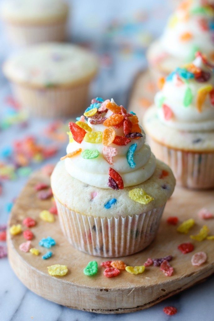 Fruity Pebble Cupcakes - Funfetti cupcakes topped with a vanilla buttercream frosting and sprinkled with colorful Fruity Pebbles!