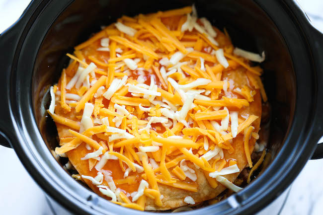 Slow Cooker Enchilada Stack - Simply turn on your crockpot and forget all about it until you have the cheesiest and creamiest enchiladas ever! It's so easy!