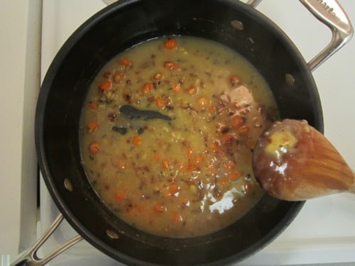 Creamy turkey and pancetta pot pie filling cooking in a saucepan.