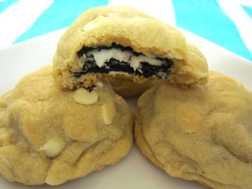 Oreo-stuffed white chocolate chip cookies with one split open to show the Oreo center.