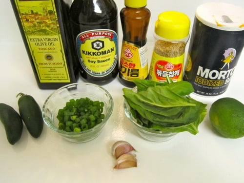 Ingredients for penne with Thai-style pesto including fresh basil, garlic, green onions, jalapeños, lime, olive oil, soy sauce, sesame oil, sesame seeds, and salt.