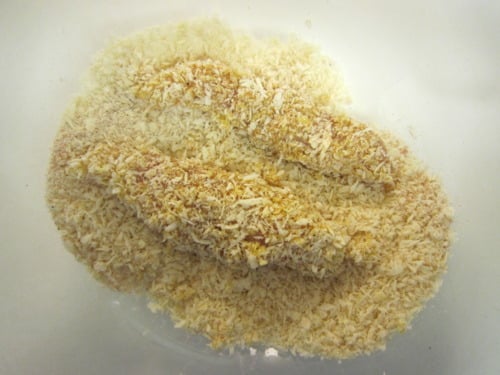 Chicken tenders coated in a honey Dijon mixture and dredged in panko breadcrumbs, ready for baking or frying.