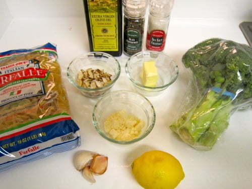 Ingredients for broccoli and bow ties: farfalle pasta, broccoli, lemon, garlic, butter, olive oil, sliced almonds, grated Parmesan, salt, and pepper.
