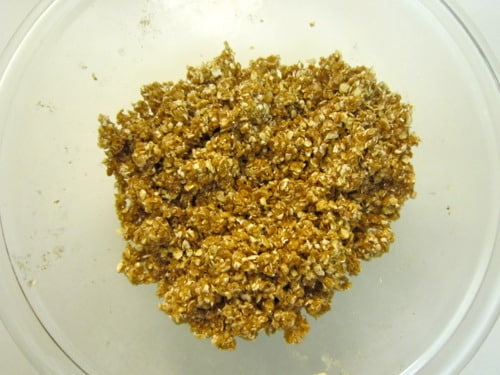 Oatmeal streusel topping mixture in a glass bowl for pumpkin muffins.