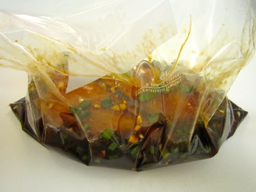 Chicken breast marinating in a Ziploc bag
