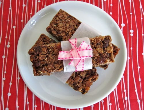 Stack of crunchy Nutella granola bars wrapped with parchment and tied with a pink ribbon.