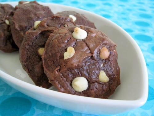 Chocolate brownie cookies with white chocolate chips served on a white dish.
