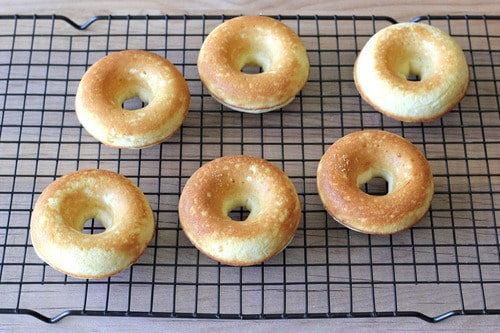 Freshly baked Nutella donuts cooling on a wire rack.