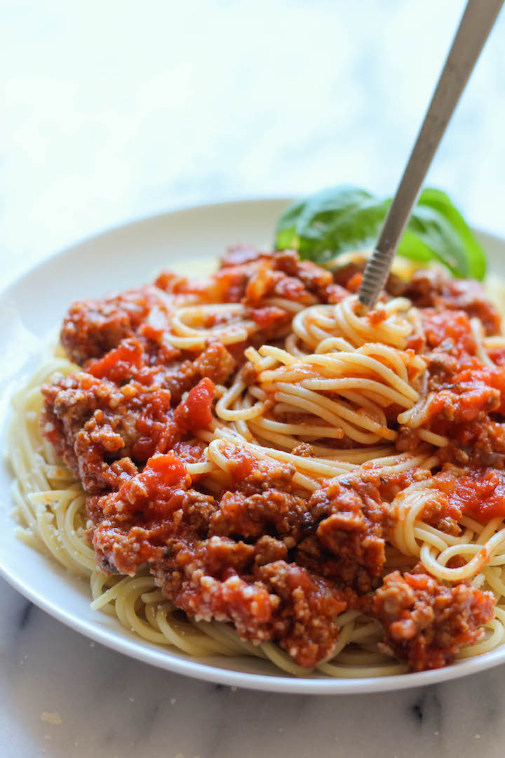 A rich and meaty slow cooker sauce served on spaghetti.