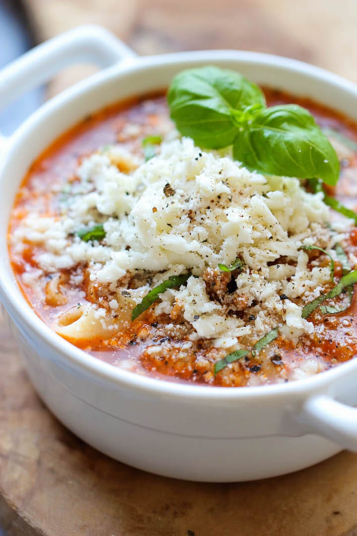 Lasagna soup served with a dollop of ricotta, parmesan, shredded mozzarella and a sprig of fresh basil.