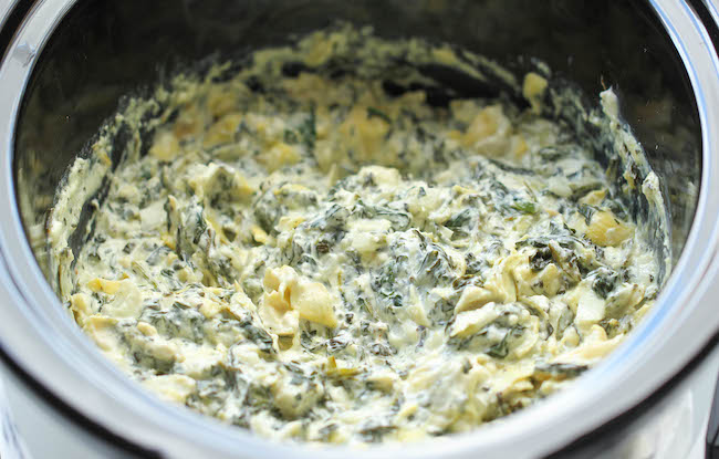 Slow Cooker Spinach and Artichoke Dip - Simply throw everything in the crockpot for the easiest, most effortless spinach and artichoke dip!