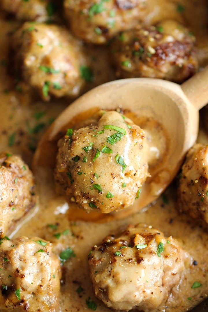 Swedish meatballs, in a creamy gravy sauce, garnished with parsley.