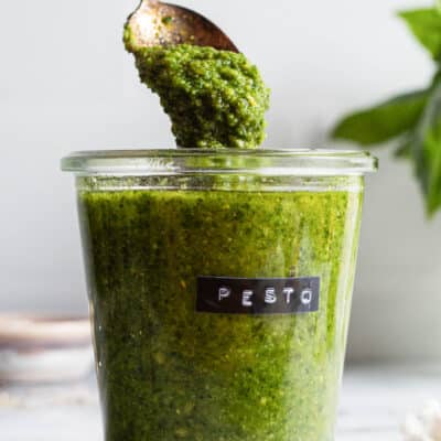 Fresh homemade pesto in a labeled storage jar