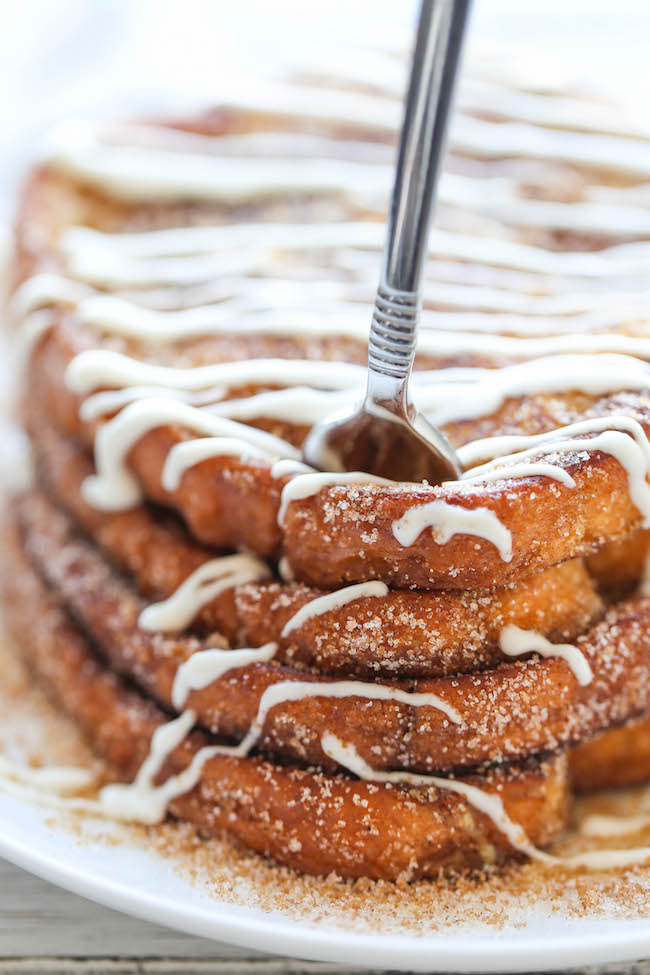 Churro French Toast - The most amazing, most buttery French toast you will ever have, coated in cinnamon sugar and drizzled with an epic cream cheese glaze!