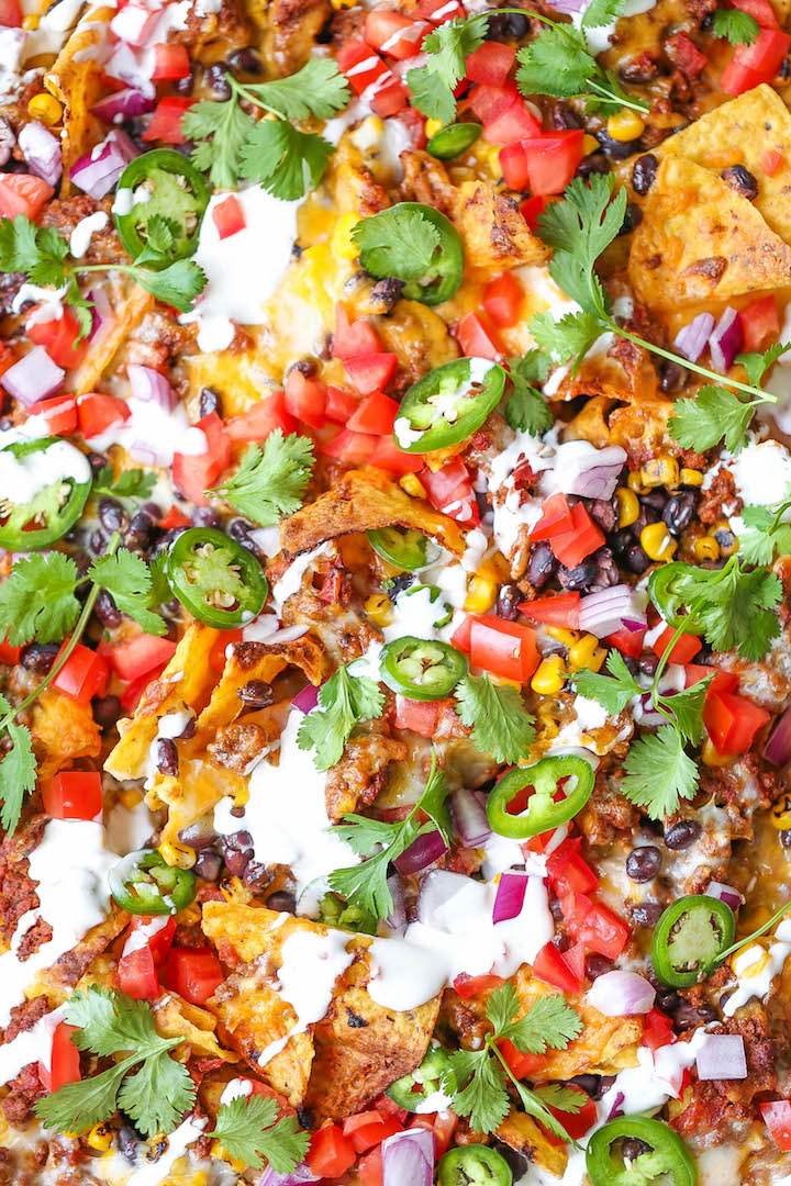 Sheet Pan Nachos - Loaded nachos that are guaranteed to be a crowd-pleaser! Simply layer your toppings, bake onto a sheet pan and serve. Done. Easy peasy!
