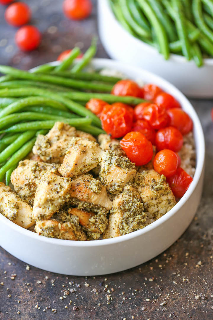 Chicken Pesto Bowls - Healthy pesto chicken bowls served with brown rice, green beans and roasted tomatoes! Easy peasy and can be prepped ahead of time!