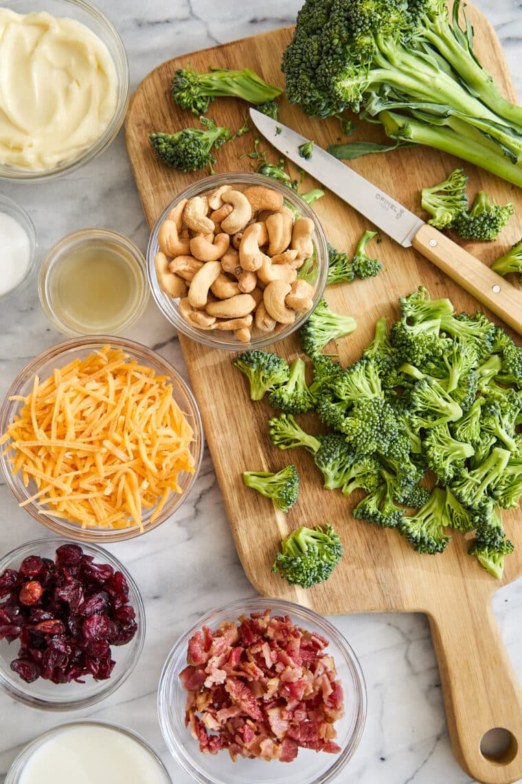 Creamy Broccoli Salad - Seriously the BEST broccoli salad ever! With cheese, cashews, red onion, crispy bacon + the creamiest dressing ever!