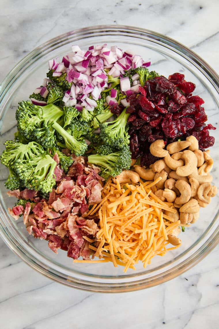 Creamy Broccoli Salad - Seriously the BEST broccoli salad ever! With cheese, cashews, red onion, crispy bacon + the creamiest dressing ever!