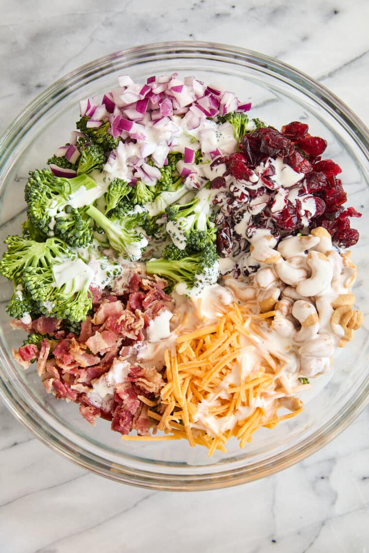 Creamy Broccoli Salad - Seriously the BEST broccoli salad ever! With cheese, cashews, red onion, crispy bacon + the creamiest dressing ever!