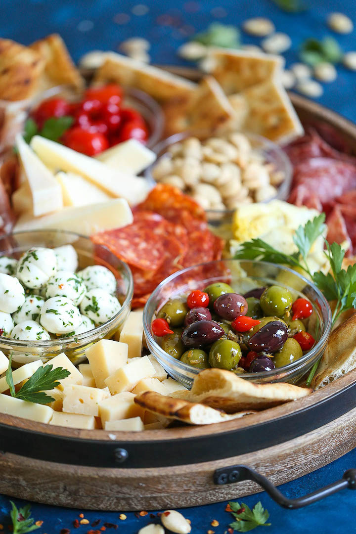 Antipasto Appetizer Cheese Board - Learn how to build the absolute PERFECT antipasto platter! It's unbelievably easy and sure to be a crowd-pleaser for all your guests! Served with cured meats, fresh cheeses, artichoke hearts, olives, nuts, peppers and focaccia!