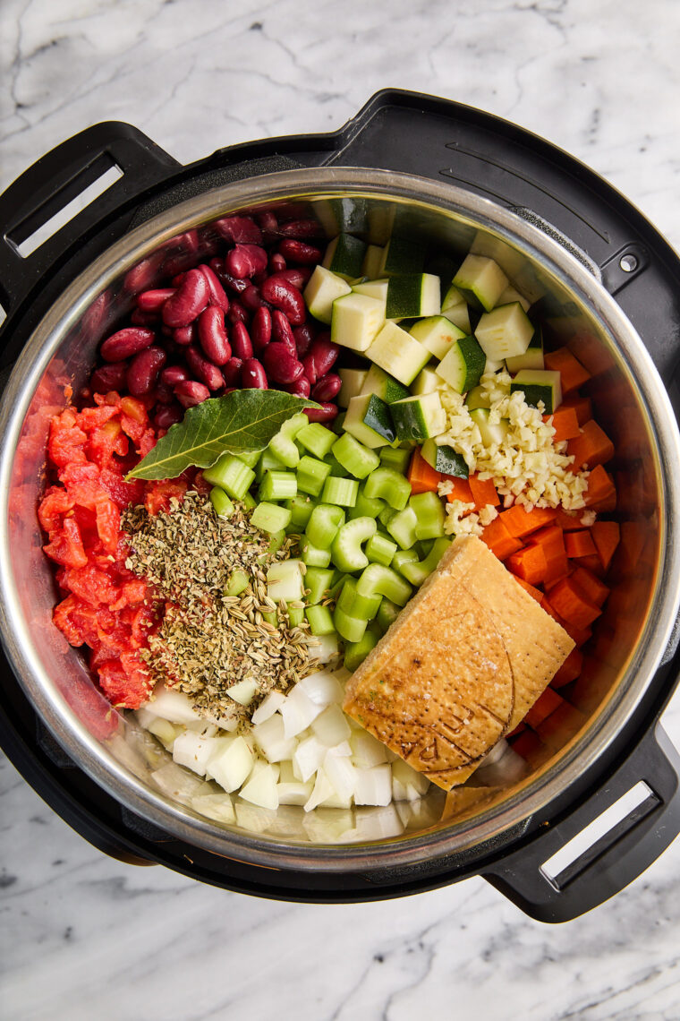 Instant Pot Minestrone Soup - So cozy, so hearty! Loaded with vegetables, beans, pasta + Parmesan rind for extra flavor. Vegetarian-friendly!