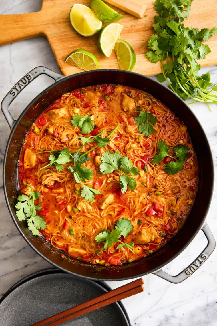 Thai Red Curry Noodle Soup - So much better than takeout! Packed with bites of tender chicken, rice noodles, cilantro, basil and lime juice!