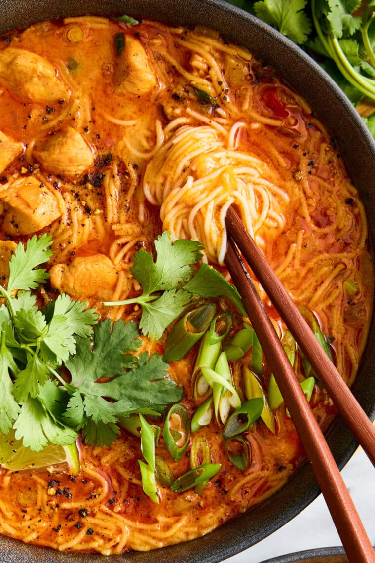 Thai Red Curry Noodle Soup - So much better than takeout! Packed with bites of tender chicken, rice noodles, cilantro, basil and lime juice!