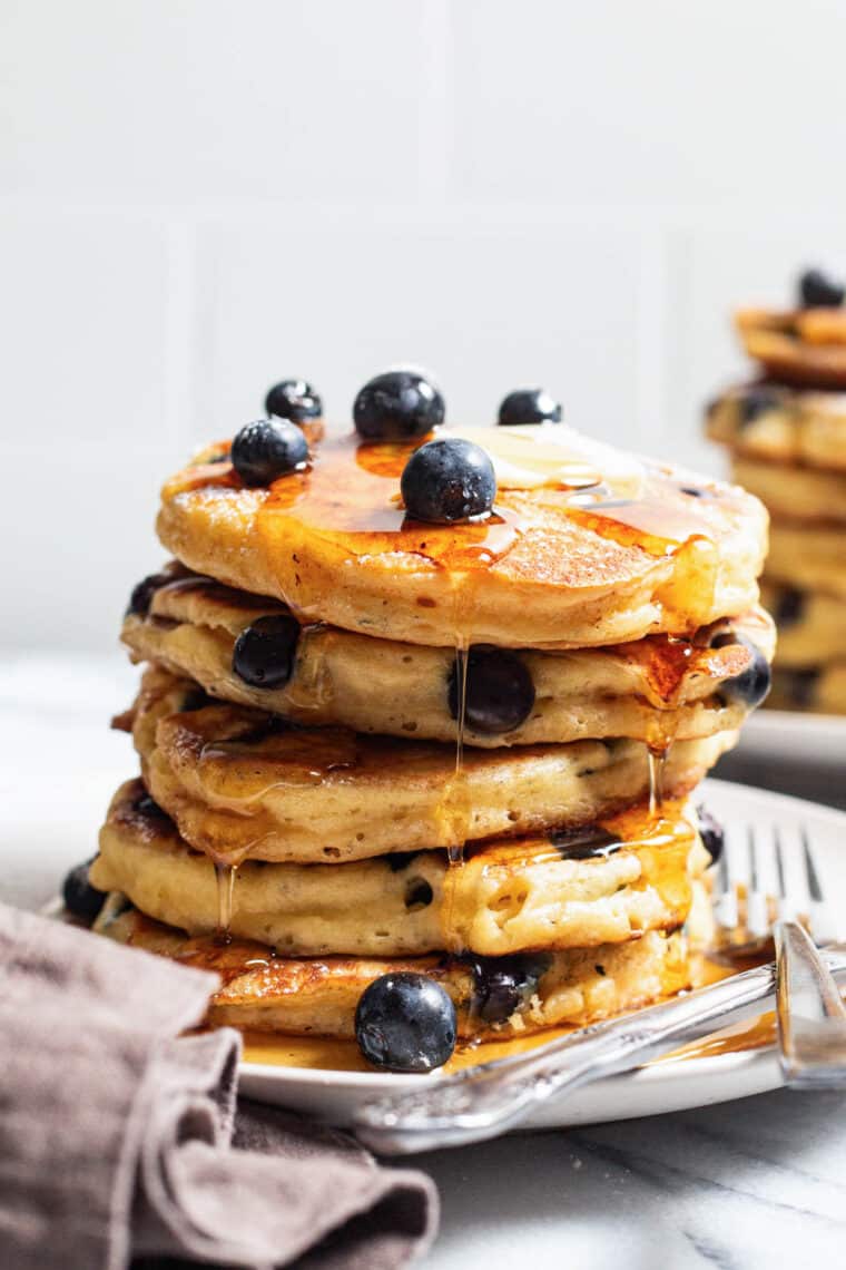 Blueberry Sour Cream Pancakes - Light, fluffy, melt-in-your-mouth buttery pancakes with juicy blueberries. Restaurant-quality right at home!