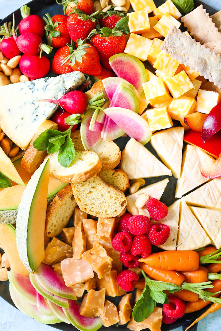 Spring Cheese Board - How to build the most PERFECT cheese board! Perfect for entertaining and impressing your guests, this cheese board is assembled with so many of our favorite Spring fruits and veggies!