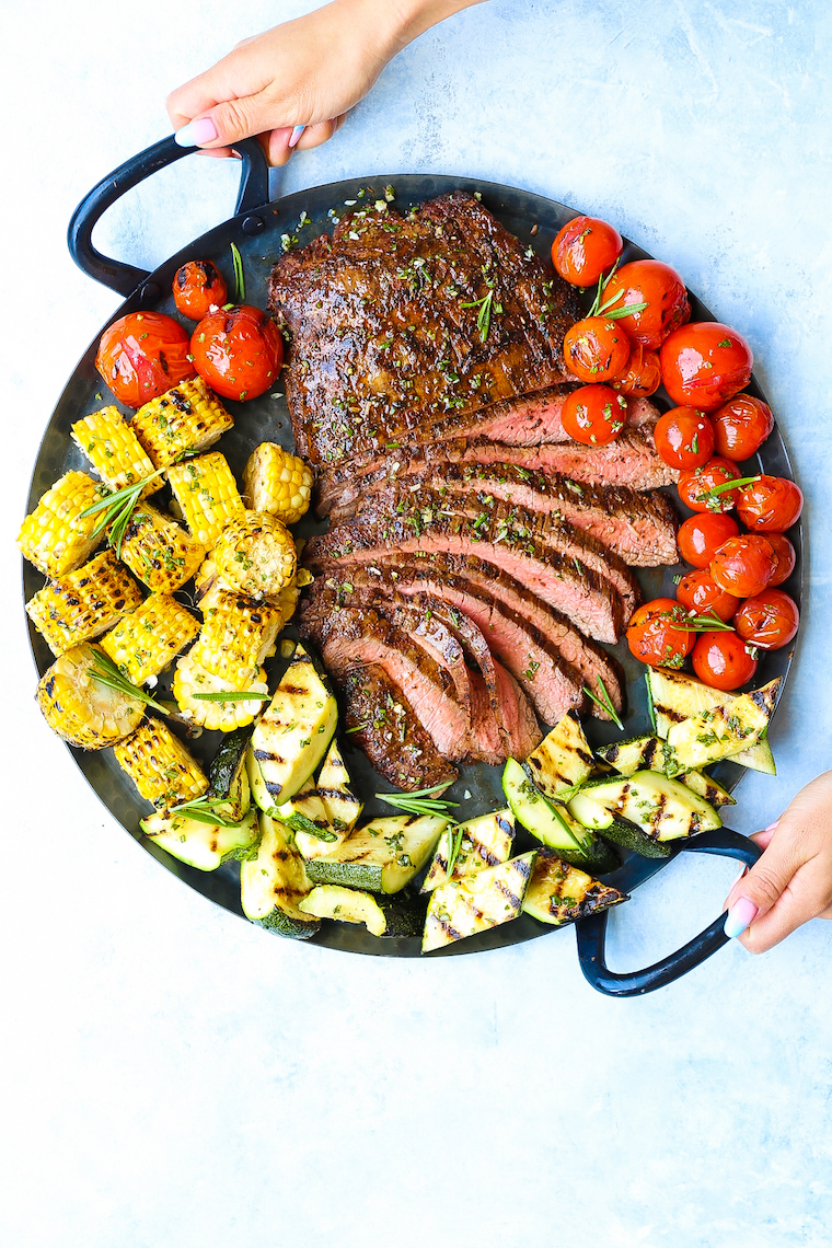 Grilled Flank Steak and Vegetables - The BEST + EASIEST tender flank steak ever! Paired so perfectly with crisp-tender grilled corn, zucchini and tomatoes!