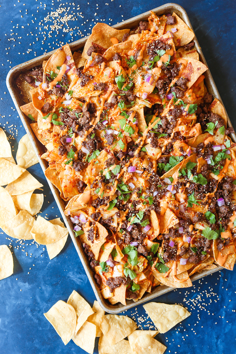 Korean Beef Nachos - These will be the BEST NACHOS of your life! Topped with everyone's favorite Korean beef, caramelized kimchi + a Sriracha mayo drizzle!