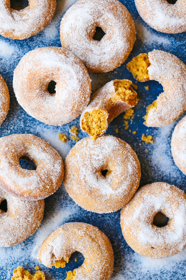 Pumpkin Cake Donuts - The MOST HEAVENLY pumpkin donuts! So moist, they just melt-in-your mouth! Coated in melted butter and cinnamon sugar. It's perfection!