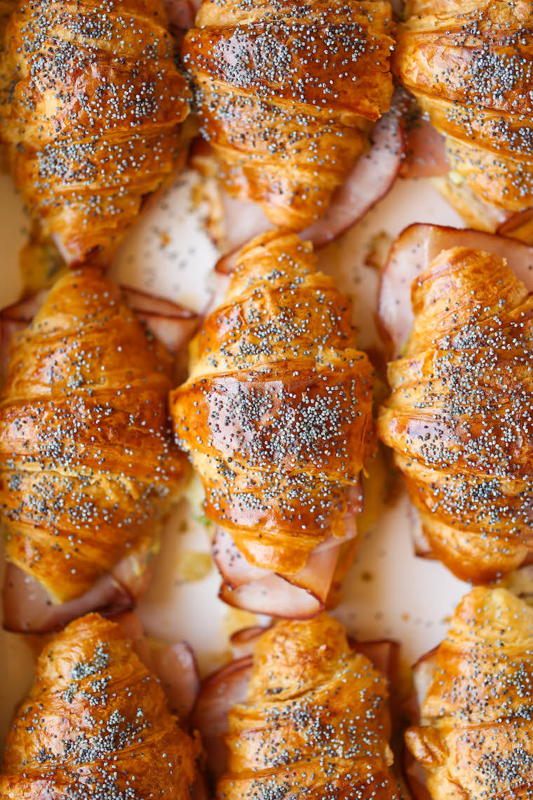 Baked Ham and Cheese Croissants - So so easy to make for a crowd! The mini croissants are toasted and flaky, baked with Dijon-honey, buttery goodness. WHOA.