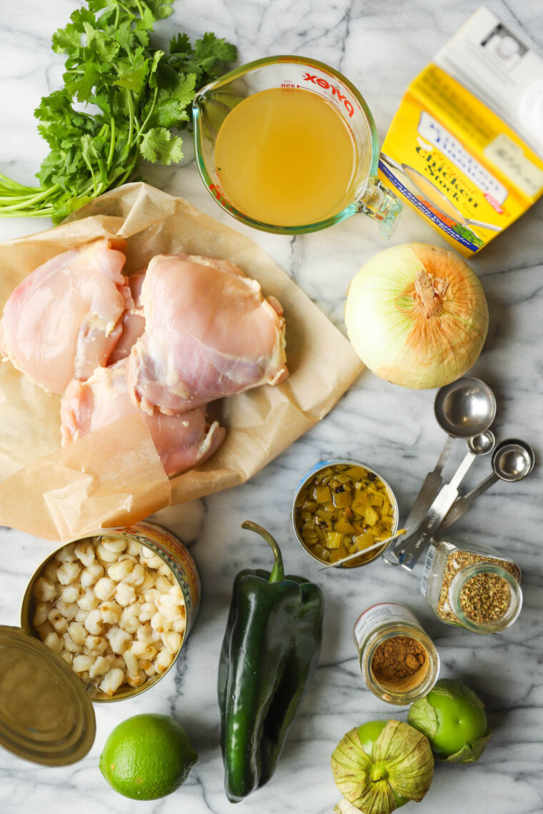 Slow Cooker Chicken Posole - Made so easily right in your crockpot! Loaded with shredded chicken, hominy and green chiles. So cozy, so good.