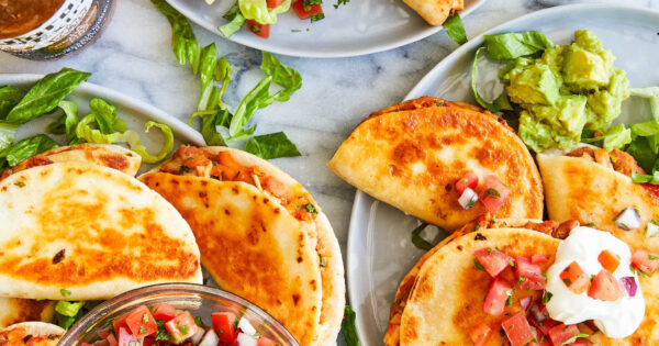 Snack-size quesadillas with refried beans, leftover rotisserie chicken, guacamole + melted cheese.