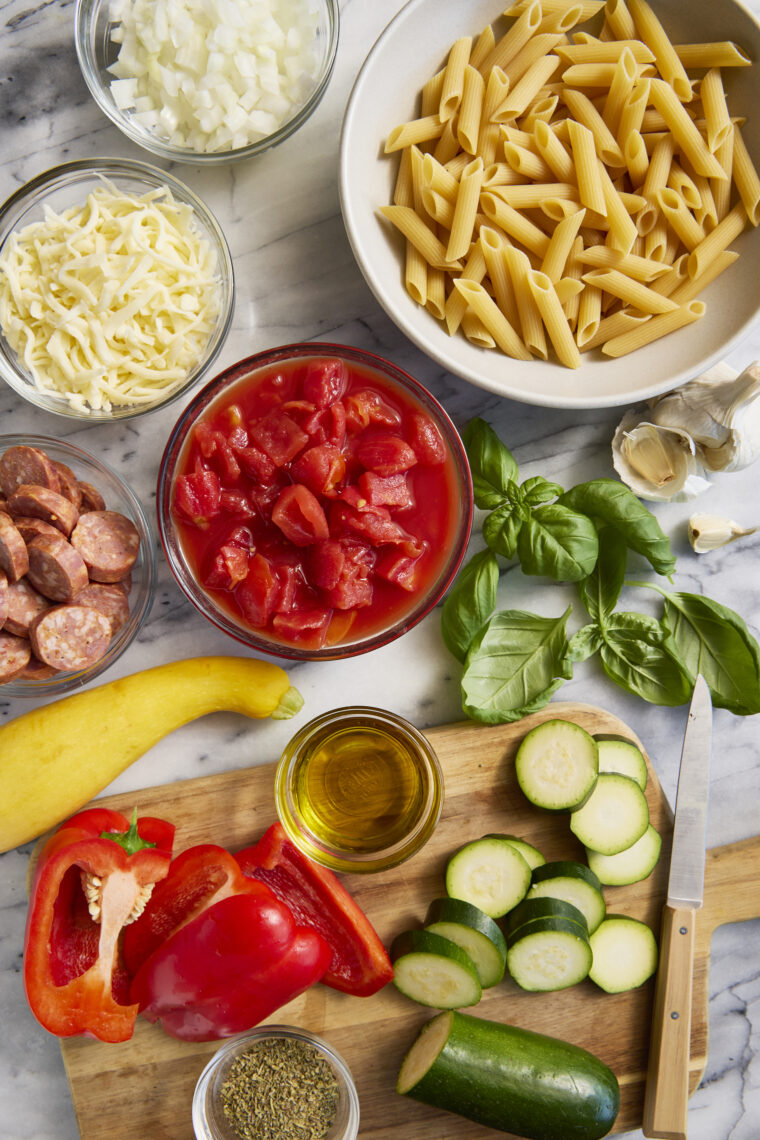 Summer Skillet Pasta - Cheesy baked pasta with the best summer vegetables and andouille sausage! Even your picky eaters will gobble this up!