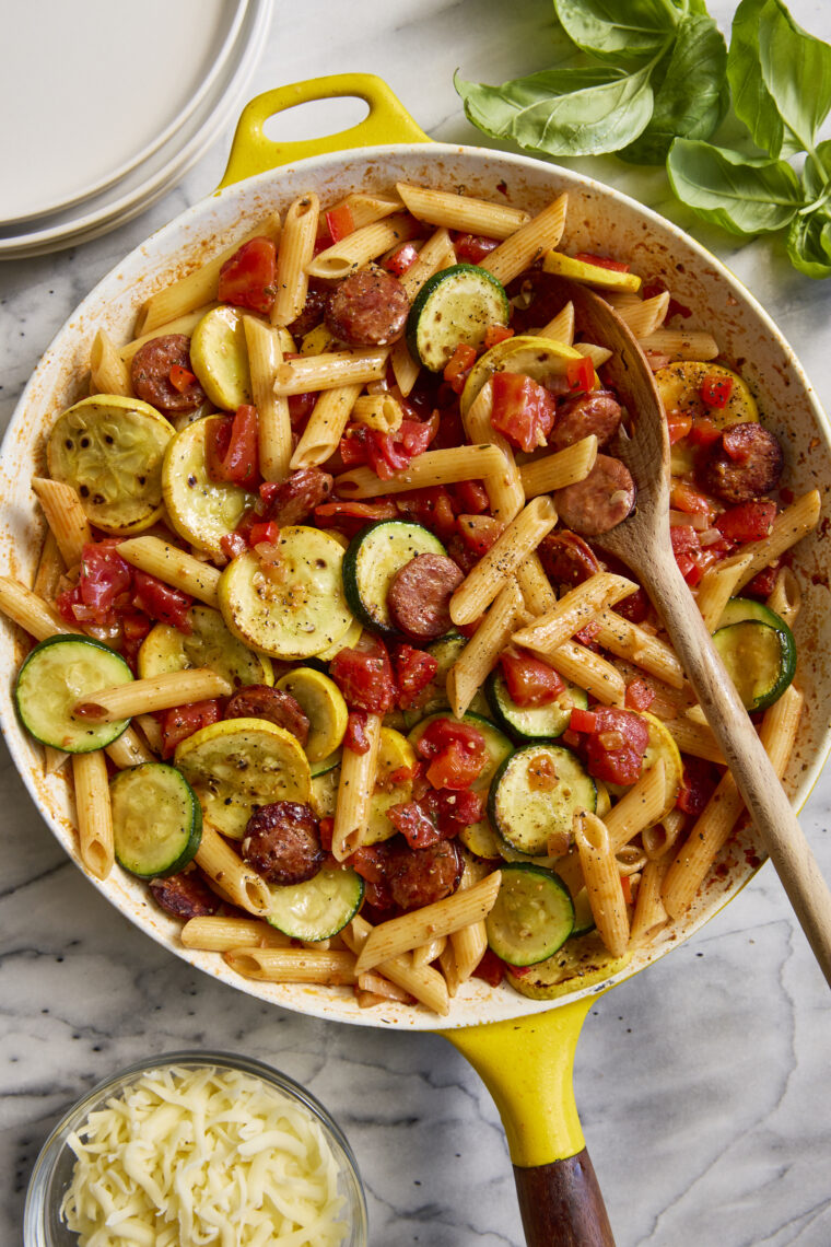 Summer Skillet Pasta - Cheesy baked pasta with the best summer vegetables and andouille sausage! Even your picky eaters will gobble this up!