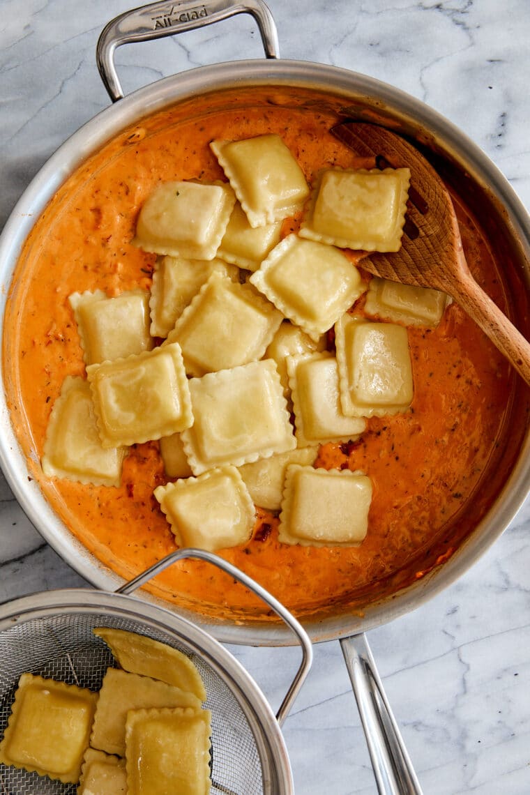 Pillow-y ravioli with the dreamiest, most velvety sun dried tomato cream sauce! A 30-minute weeknight dinner yet fancy enough for company!