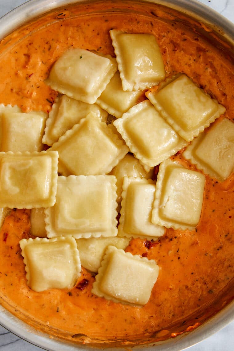 Pillow-y ravioli with the dreamiest, most velvety sun dried tomato cream sauce! A 30-minute weeknight dinner yet fancy enough for company!