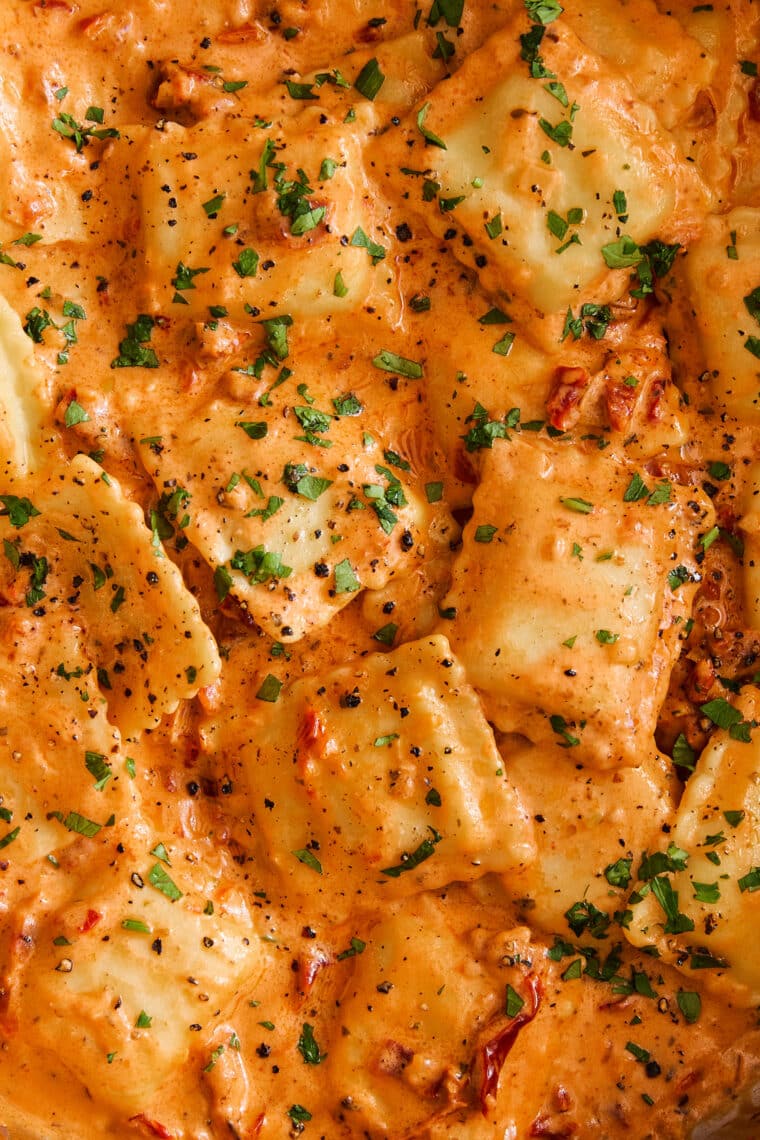 Pillow-y ravioli with the dreamiest, most velvety sun dried tomato cream sauce! A 30-minute weeknight dinner yet fancy enough for company!