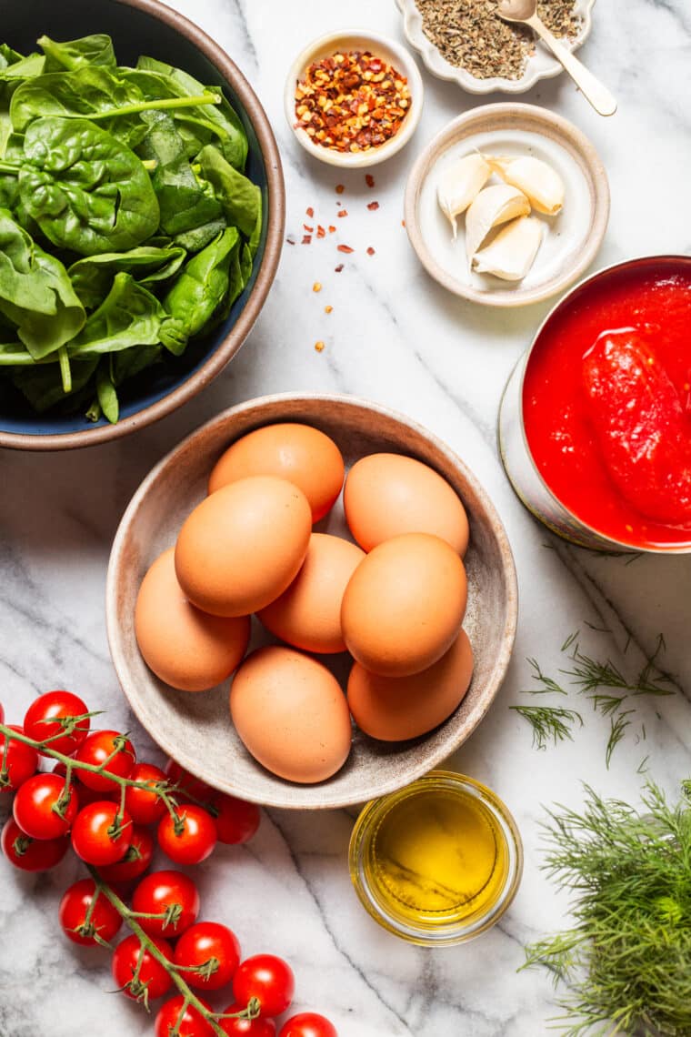 Eggs in Purgatory - An easy, rustic, one pan dish with eggs poached in a rich, savory, garlicky tomato sauce. Best served with all the crusty bread for dunking!