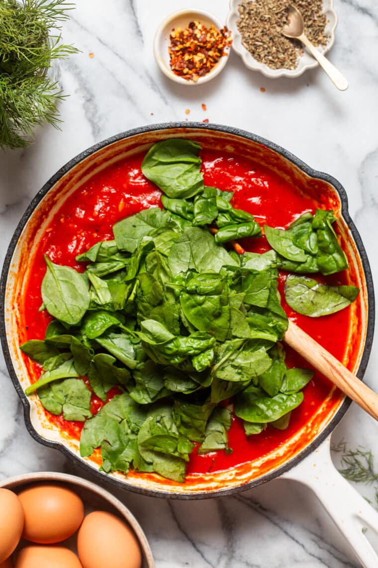 Eggs in Purgatory - An easy, rustic, one pan dish with eggs poached in a rich, savory, garlicky tomato sauce. Best served with all the crusty bread for dunking!