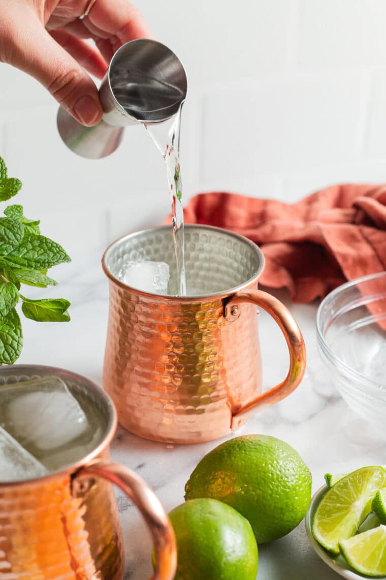 Adding vodka to Moscow Mule cocktail